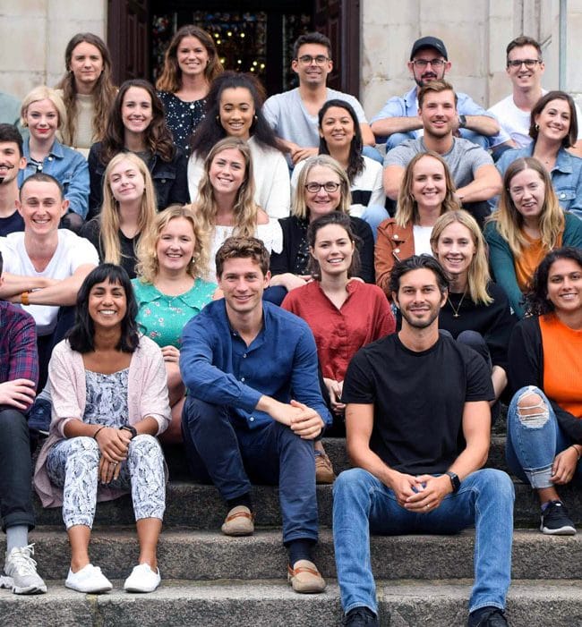 The MyTutor team sat together on some steps